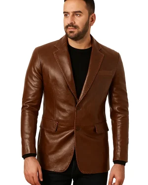 Men’s tan leather shirt jacket with western yoke, snap buttons, and slim-fit silhouette.